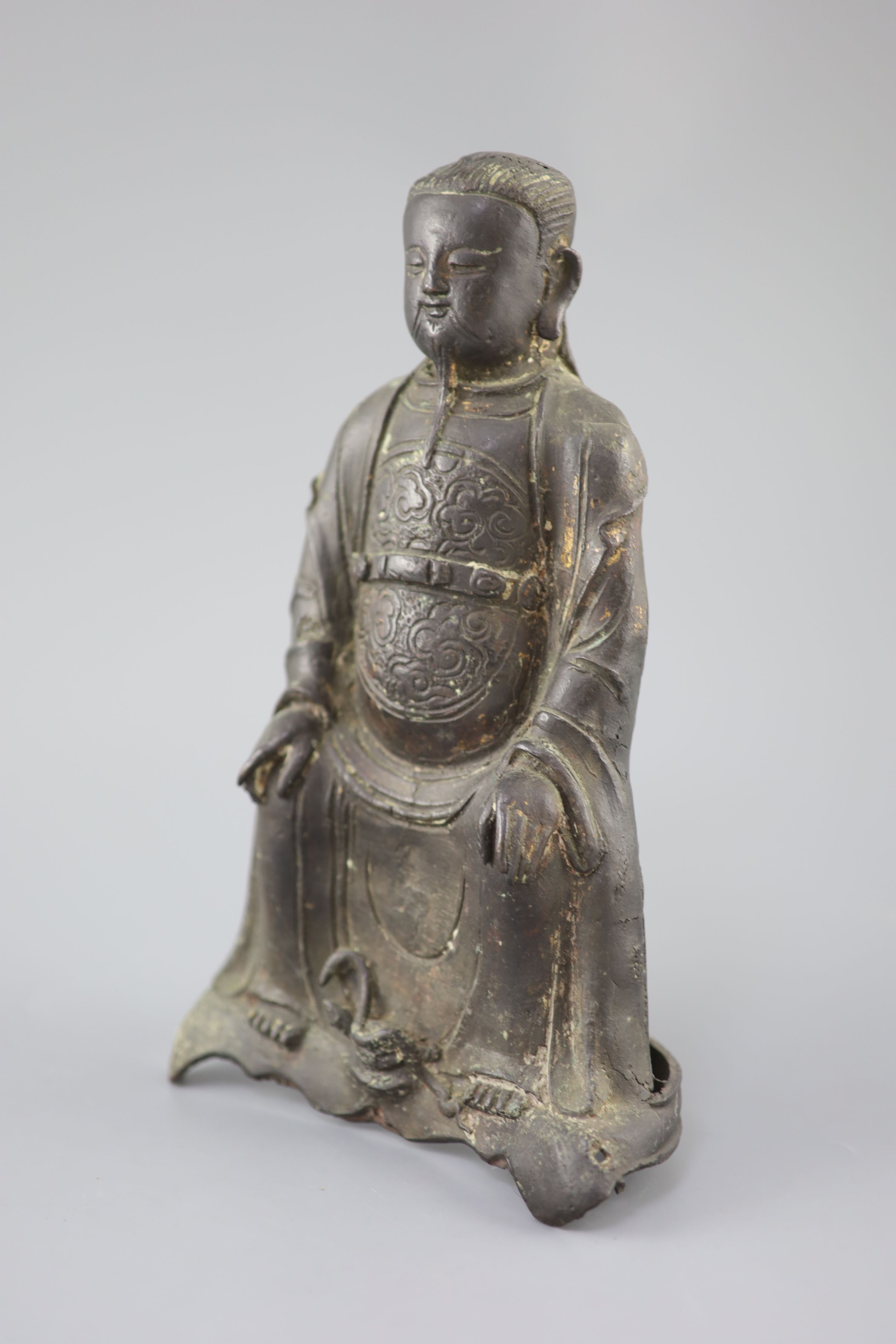 A Chinese bronze seated figure of Zhenwu, late Ming dynasty, 29cm high, casting faults, Provenance - A. T. Arber-Cooke